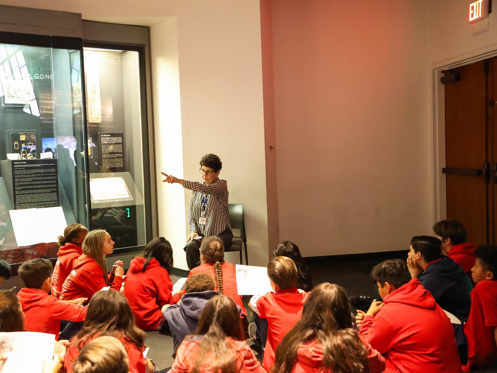 A student group with a museum educator in the exhibits