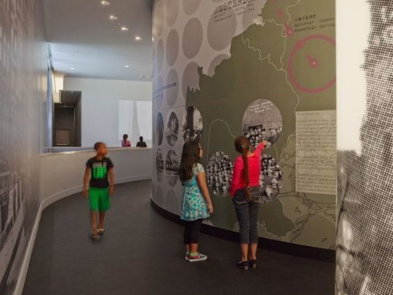 Younger students at an exhibit wall