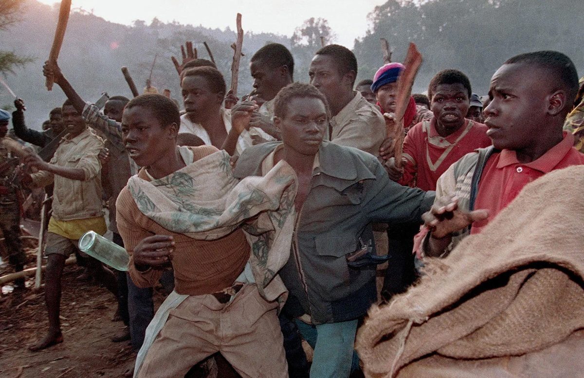 A crowd of Rwandan refugees angered by the closing of the border run to the border bridge to force their way into Zaire, Aug. 21, 1994. (AP Photo/Jean-Marc Bouju)
