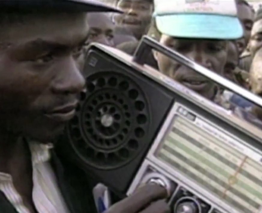 Man listening to RTLM broadcast, Words that Kill, 2014. Aegis Trust- USC Shoah