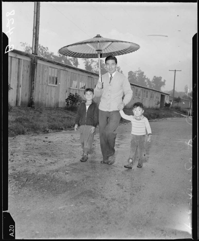 Japanese parasol for spring showers at Santa Anita Park assembly center. Evacuees later are transferred to War Relocation Authority center for the duration. 1942. Courtesy of the National Archives and Records Administration